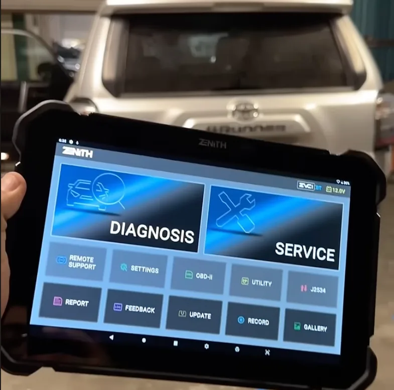 A diagnostic scan tool held in front of a four wheel drive, its screen showing the diagnosis and service menu.