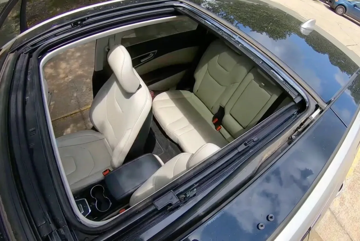 An open roof aperture with the glass panel removed and the seats visible below.